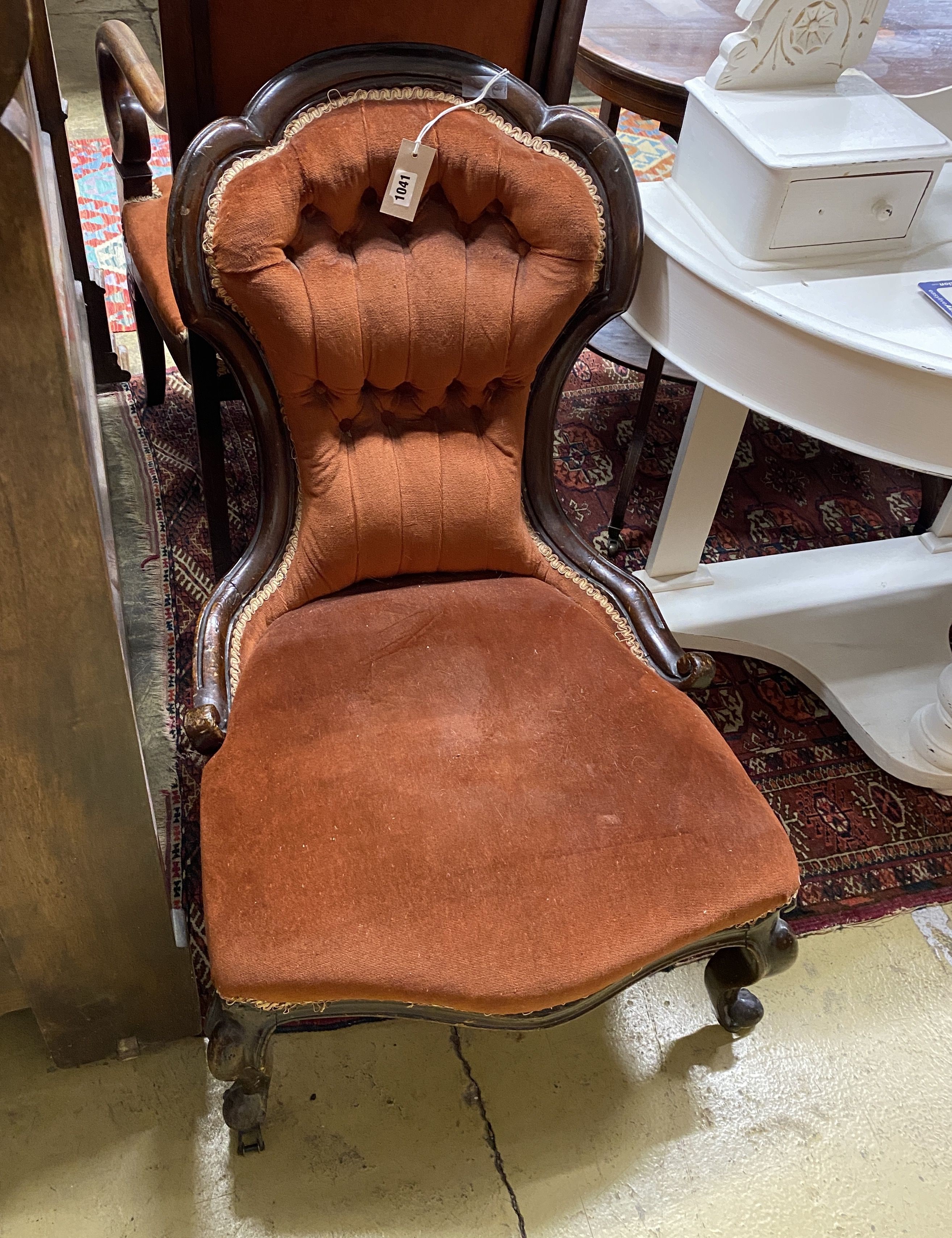 A Victorian carved walnut button back nursing chair